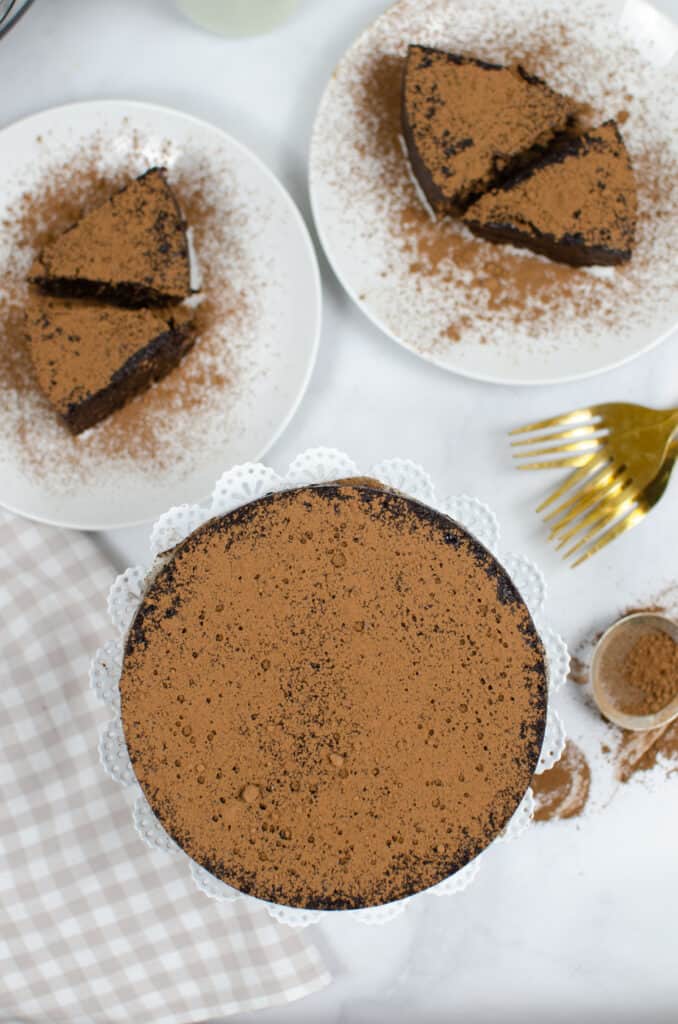 overhead shot of a instant pot made flourless chocolate cake with coacoa dusted on top