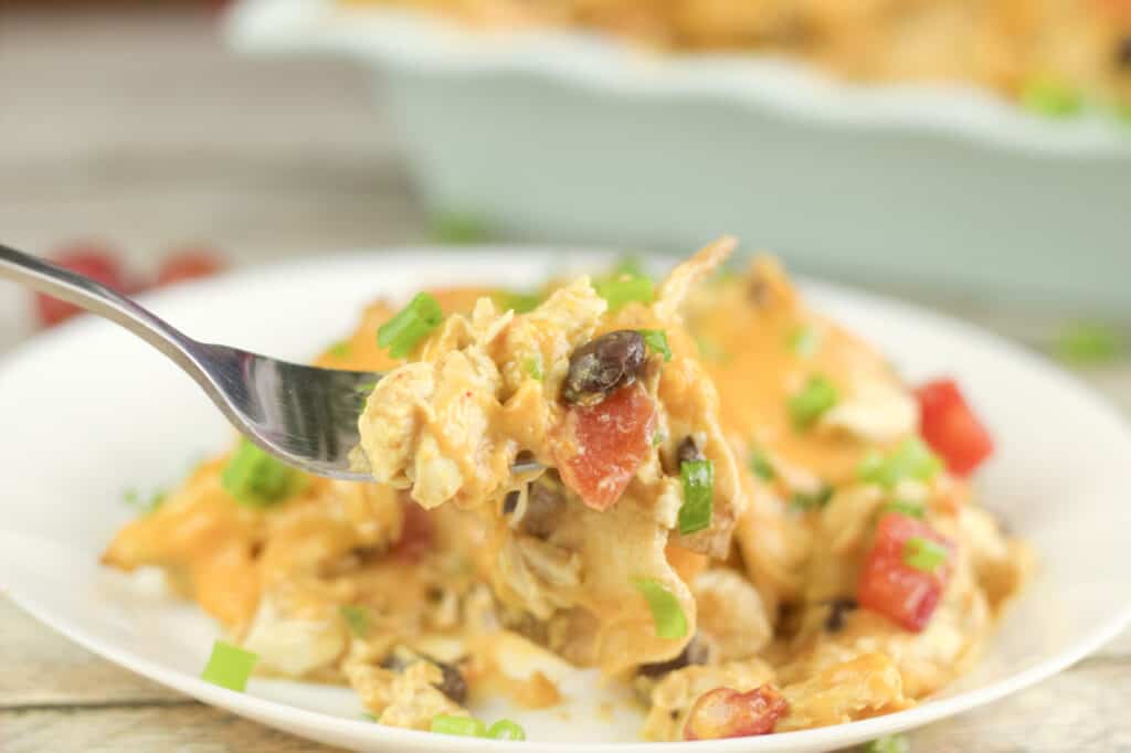 chicken taco casserole on a fork with diced green onions