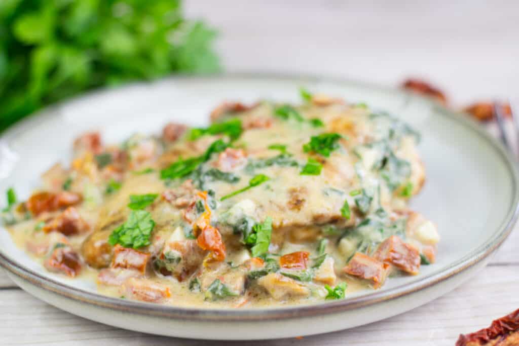one pan creamy tuscan chicken recipe on a ceramic plate