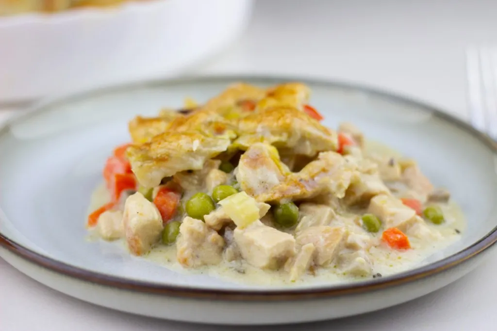 Overhead shot of chicken pot pie with flaky crust and steam vents