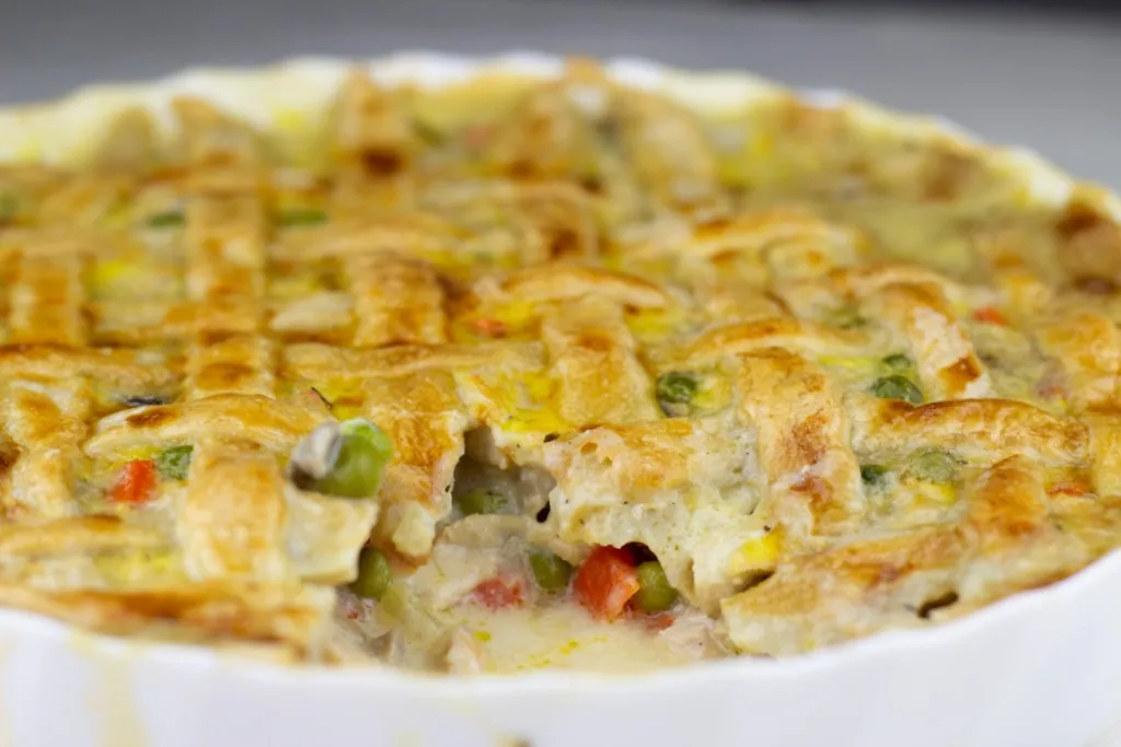 Close-up of golden pot pie crust brushed with egg wash