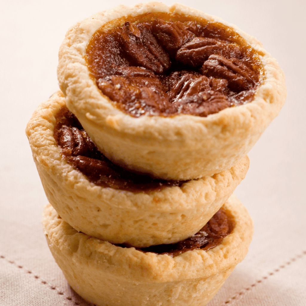 mini pecan tarts recipe that are stacked on each other