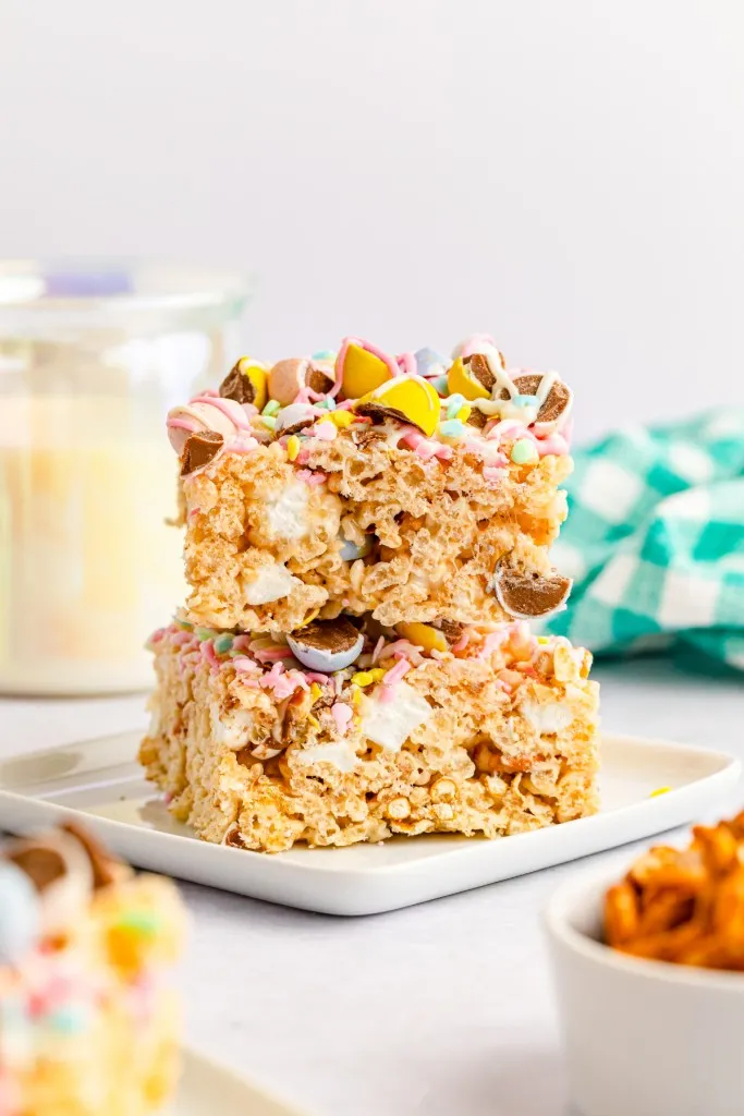 stacked Cadbury Mini Egg Rice Krispies Treats on a small square white plate