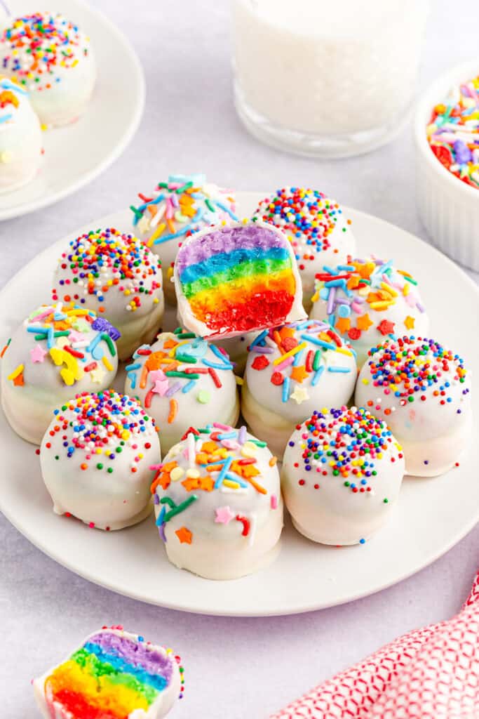 beautiful rainbow inside a cake mix ball covered in white chocolate colorful sprinkles