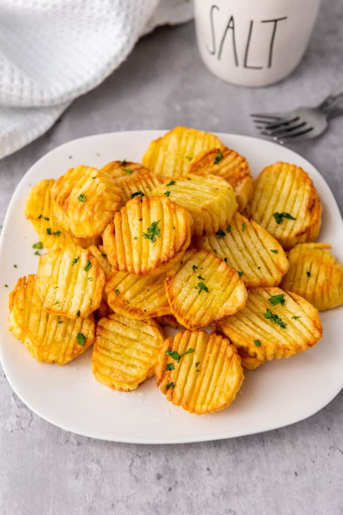 a white plate full of homemade accordion potatoes recipe made in an air fryer