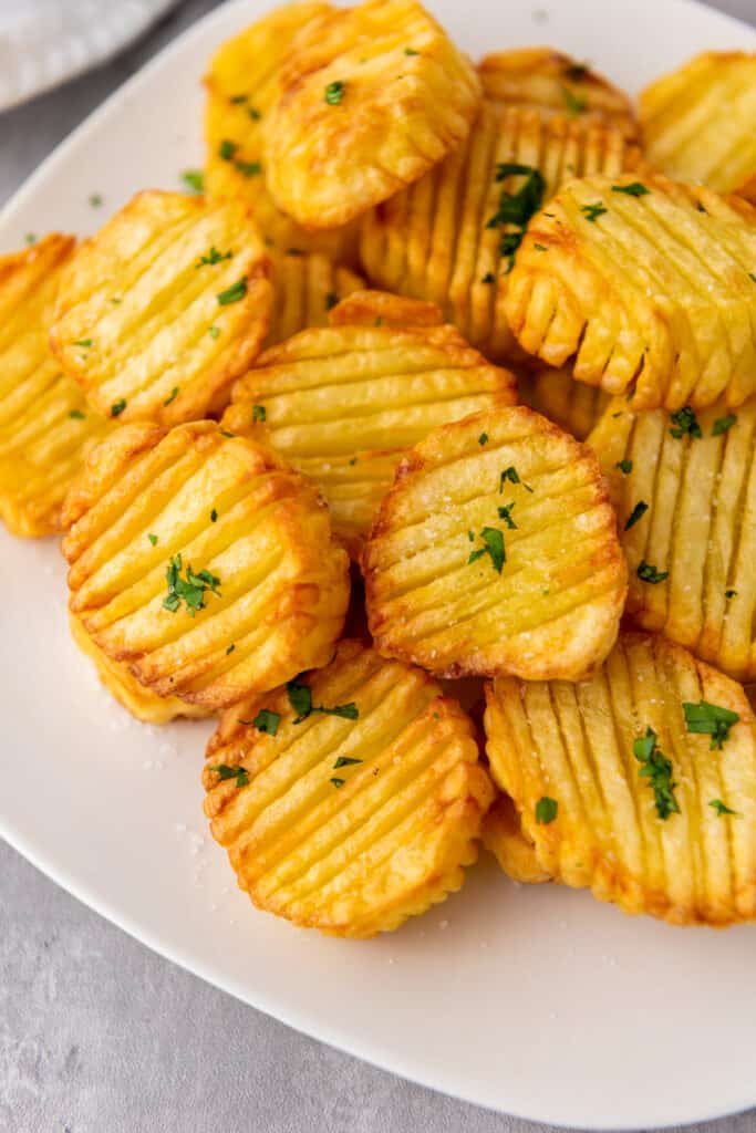 overhead image of accordion potatoes with fresh herbs made in the air fryer