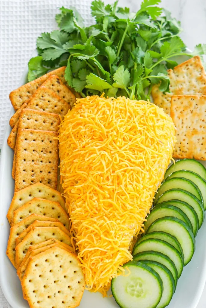 overhead shot of carrot shaped cheese ball. The best ever Easter Cheese ball with cream cheese and bacon.