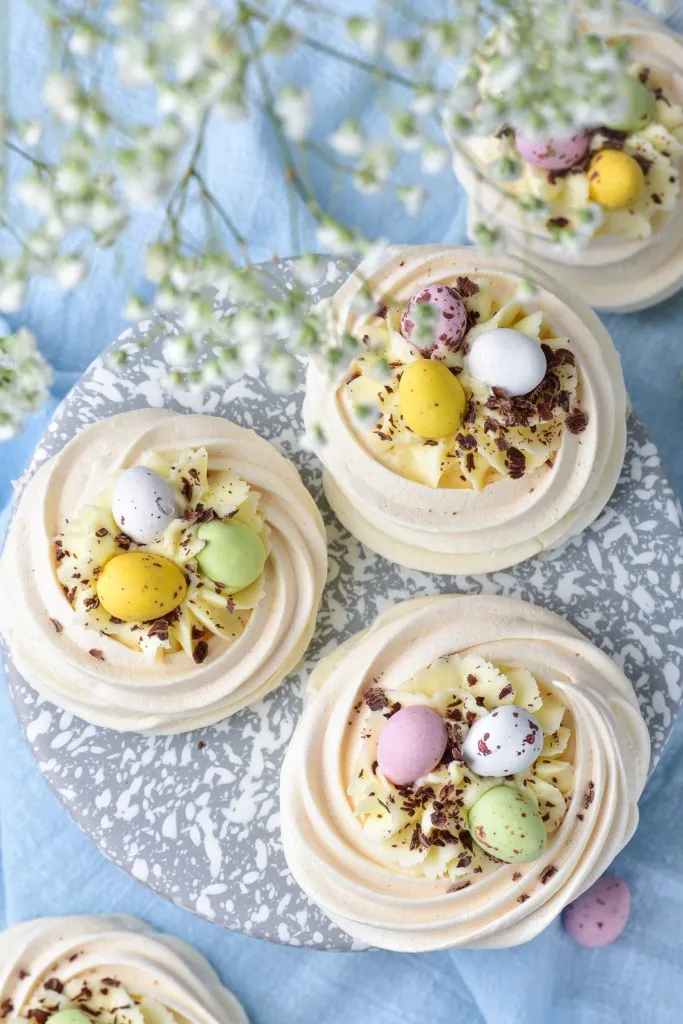overhead shot photo of easter meringue nests with cream cheese filling