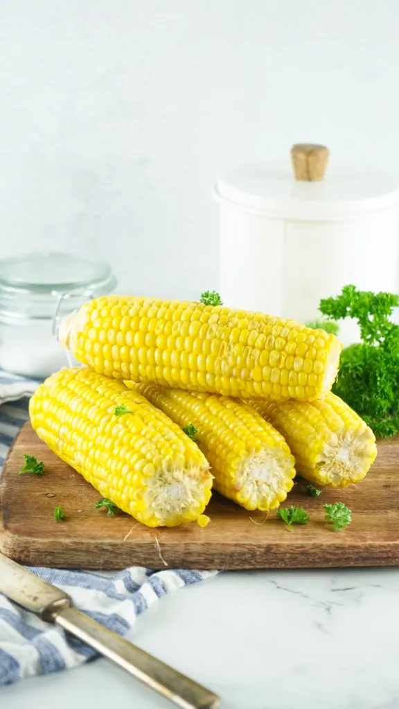 side view of instant pot corn on the cob on a wooden cutting board