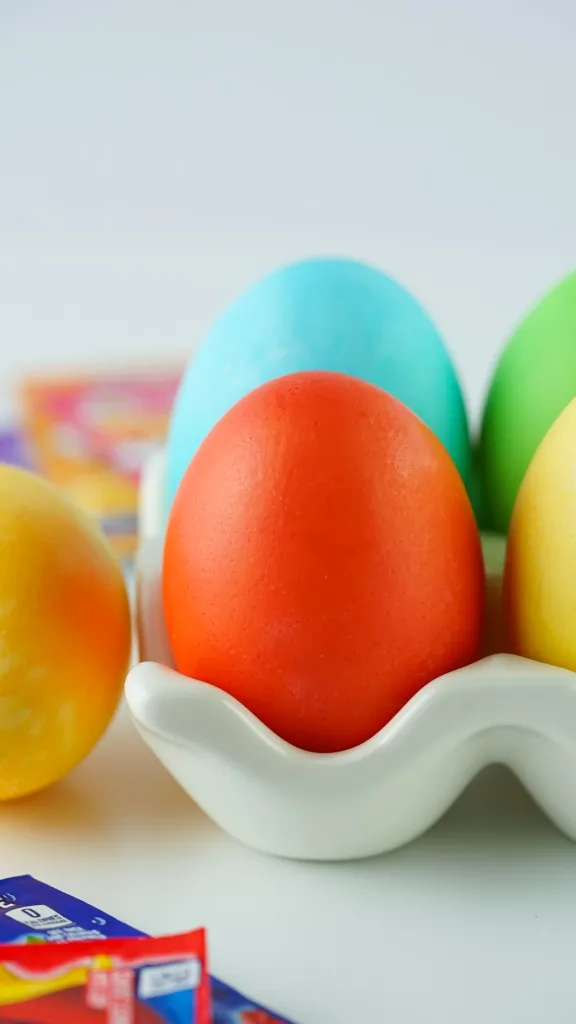 close up shot of a vibrant red and orange colored easter eggs dyed with kool aid