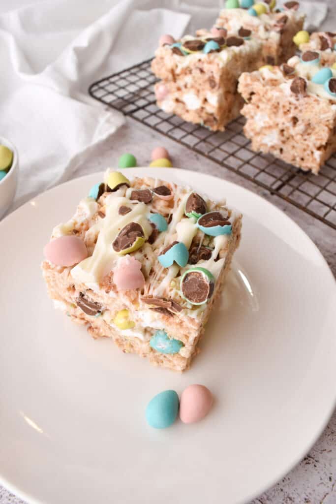 easter rice krispies treats on a white place and wire rack