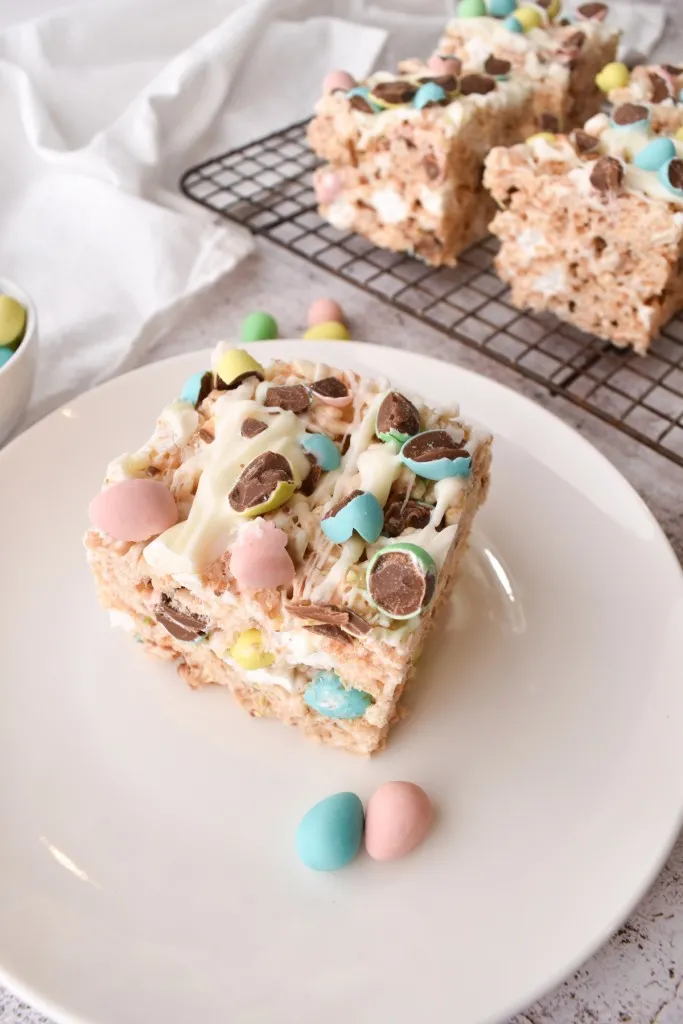 easter rice krispies treats on a white place and wire rack