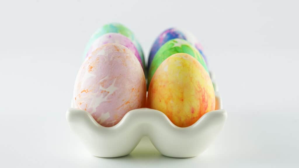 ceramic egg tray with tissue dyed eggs of different colors