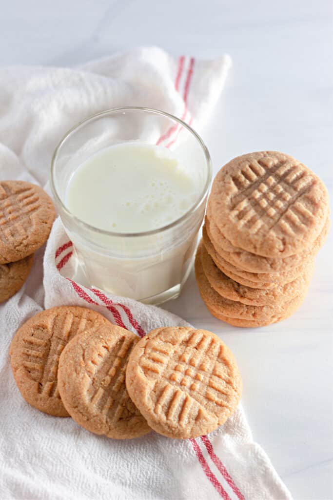 overhead shot of peanut butter cookies next to a glass of milk