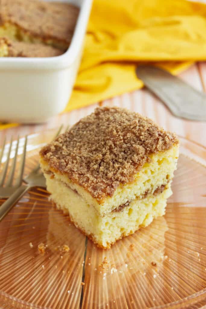overhead view of crumbly streusel topping on a coffee cake on an amber colored glass plate