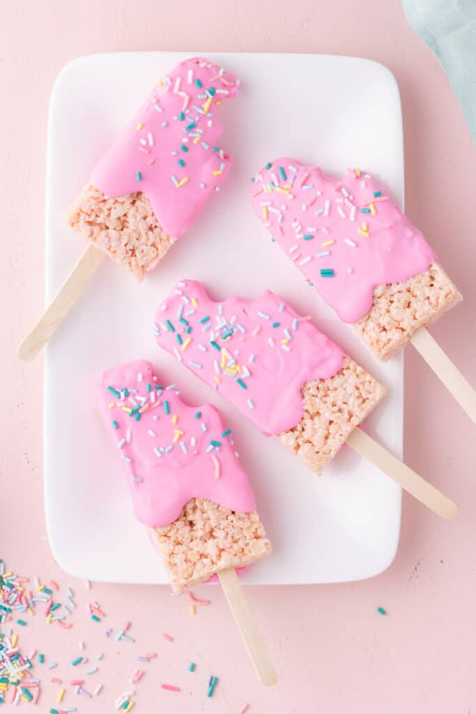 Overhead view of assembled Pink Popsicle Rice Krispie Treats on a white plate.