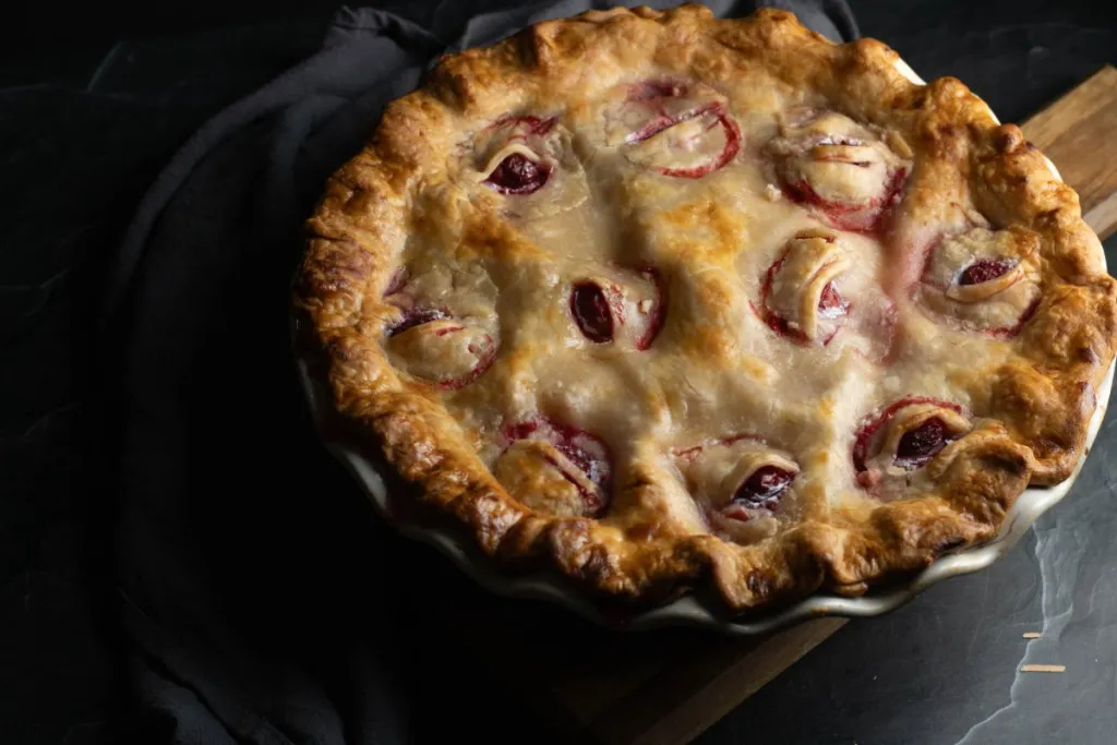 Freshly baked Eyeball Pie on a dark countertop.