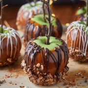 Best caramel apples on a wooden board.