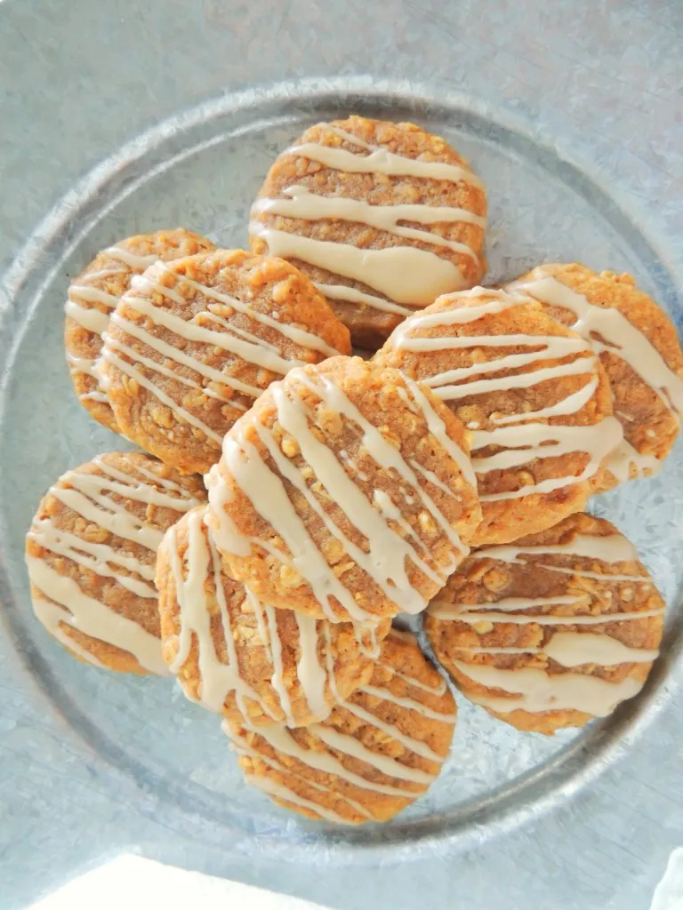 Overhead view of stacked pumpkin oatmeal cookies in a bowl.