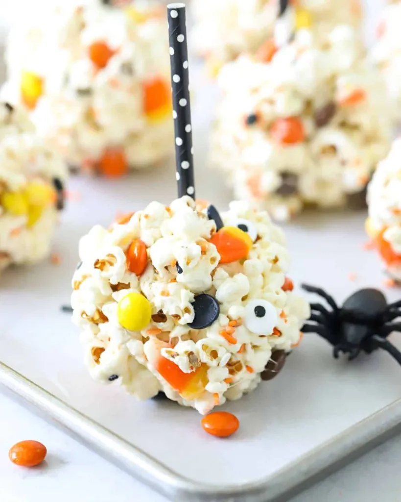 spooky halloween popcorn balls with eyeballs and spiders