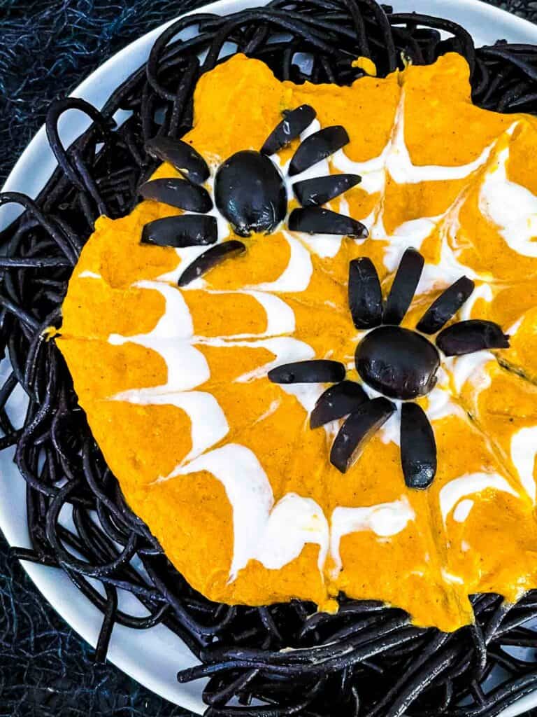 black colored pasta with a pumpkin sauce