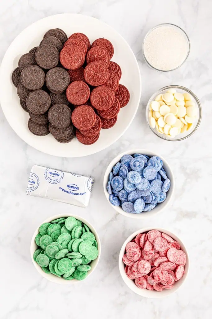 Ingredients for Christmas Oreo presents on a marble countertop.