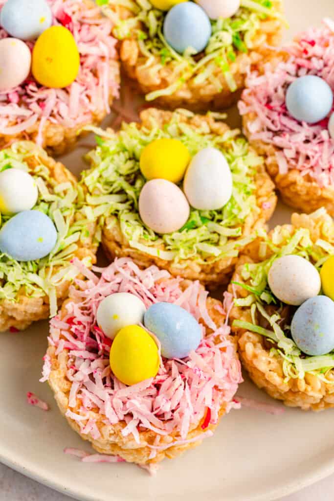 overhead shot of side view of easter rice krispies nests with green and pink coconut grass