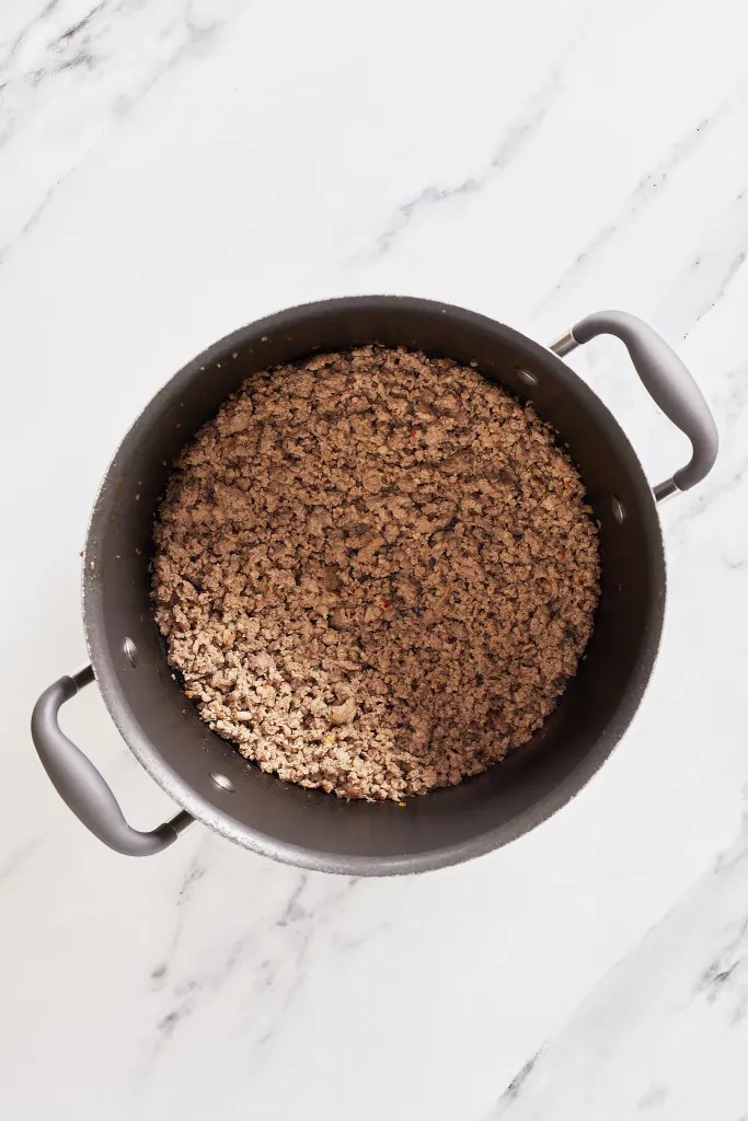 Overhead view of pot with Italian hot sausage.
