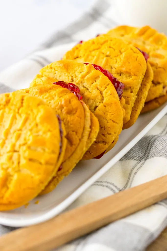 Close up of peanut butter and jelly cookie sandwiches on a tray.