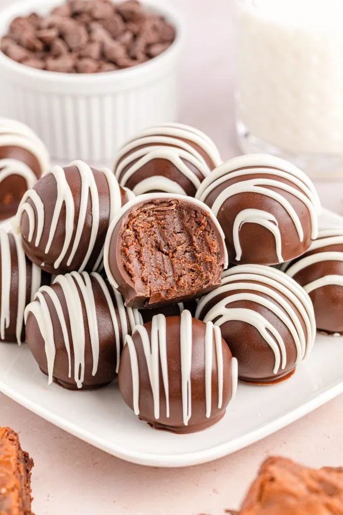 Close up shot of piled brownie balls with a bite taken out of the center brownie ball.