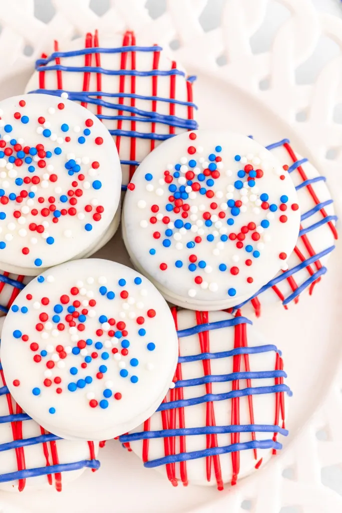 Overhead view of patriotic Oreo cookies piled on a white plate.