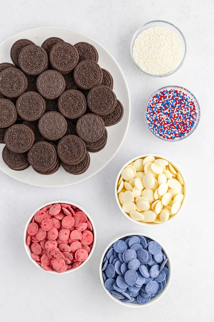 Ingredients for patriotic Oreo cookies on a white countertop.