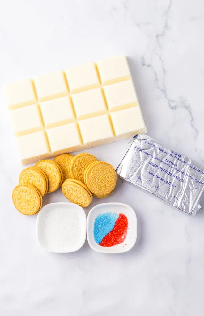 Ingredients for snow cone Oreo truffles on a marble countertop.