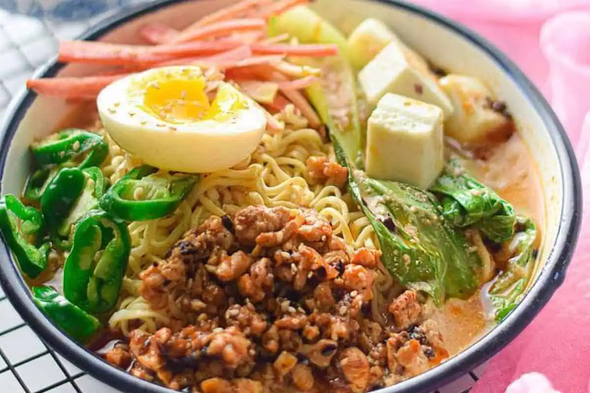 Ramen with veggies and eggs in a bowl.