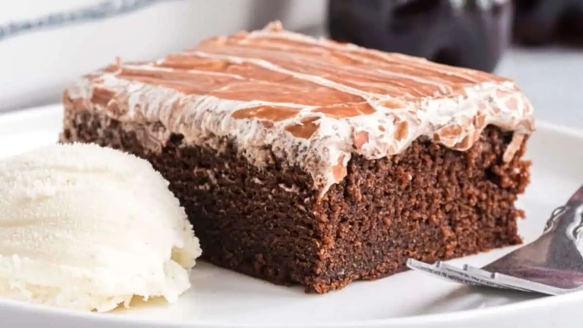 A slice of copycat coca cola cake on a plate.