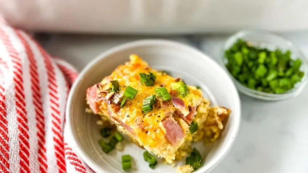 a serving of ham and cheese tater tota casserole on a plate.