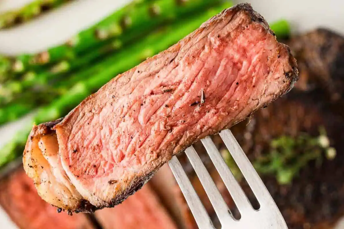 A piece of steak on a fork.