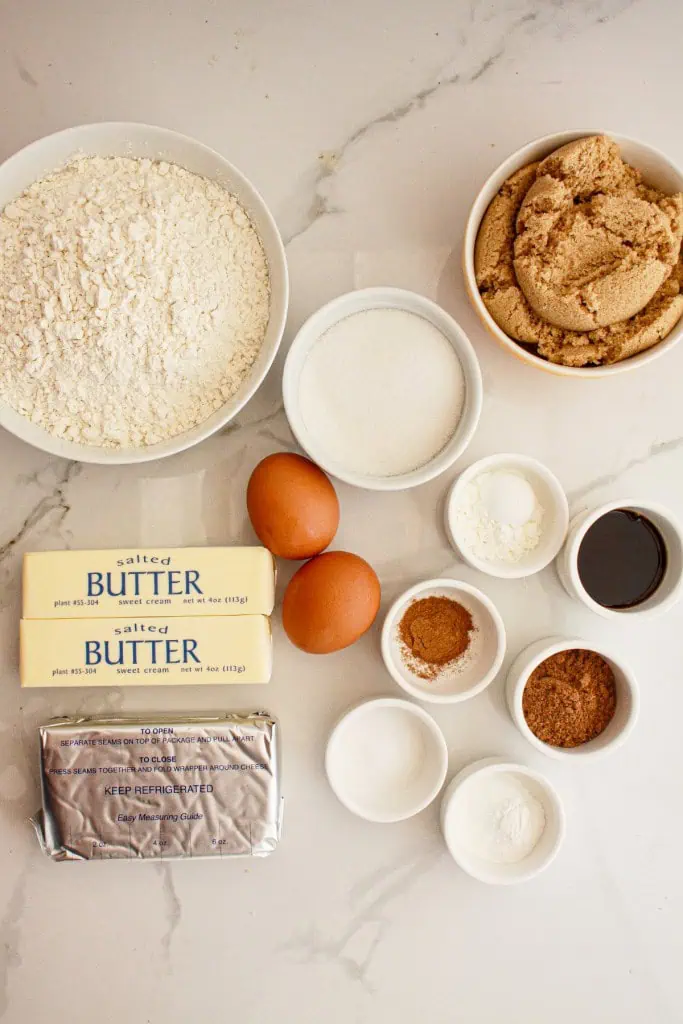 Pumpkin cheesecake cookies ingredients on a marble countertop.
