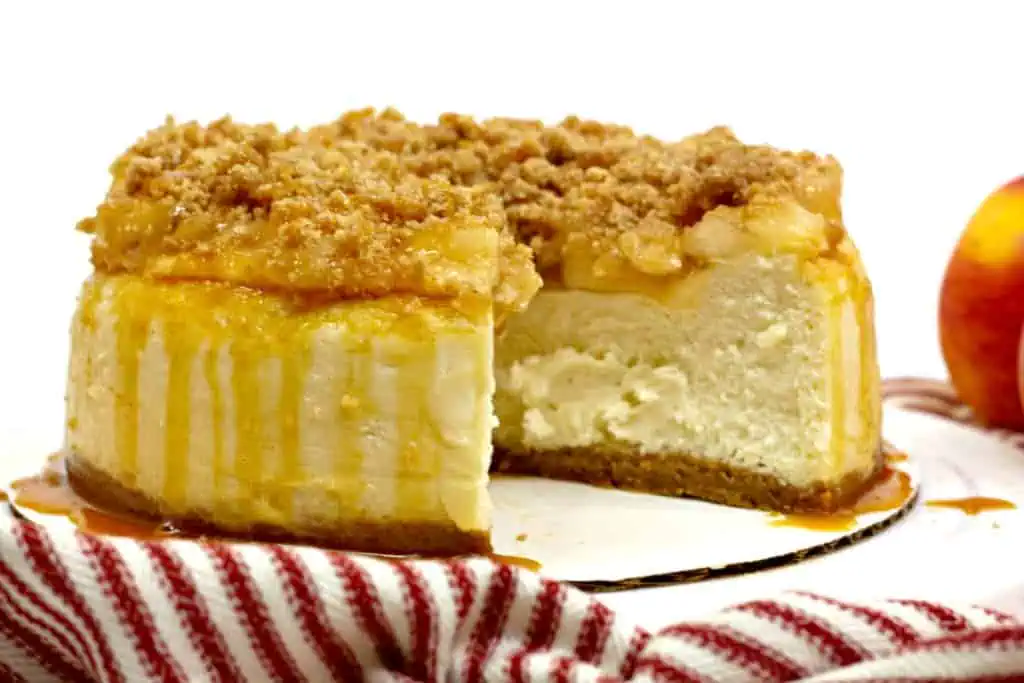 Instant Pot apple crumble cheesecake with a slice removed.
