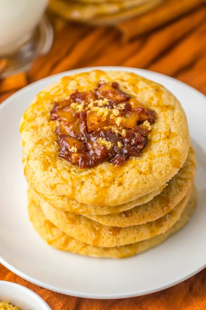 Close up of apple spiced cookies stacked on a white plate. 