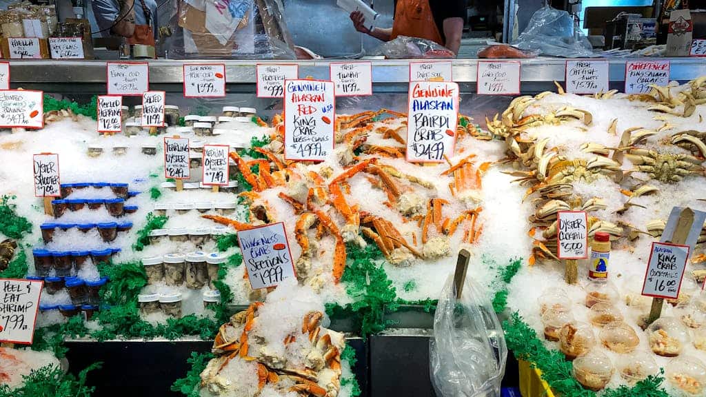 Fresh seafood display with crabs and oysters at a market in Seattle.