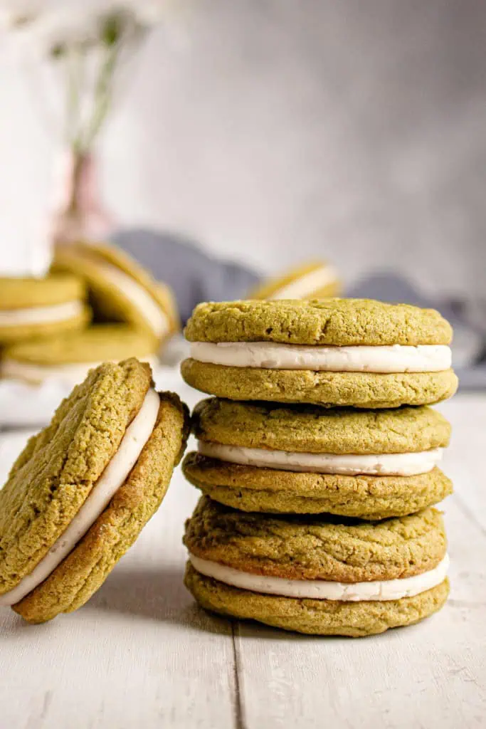 Stack of vibrant green Matcha Cream Sandwich Cookies and one leaning next to it