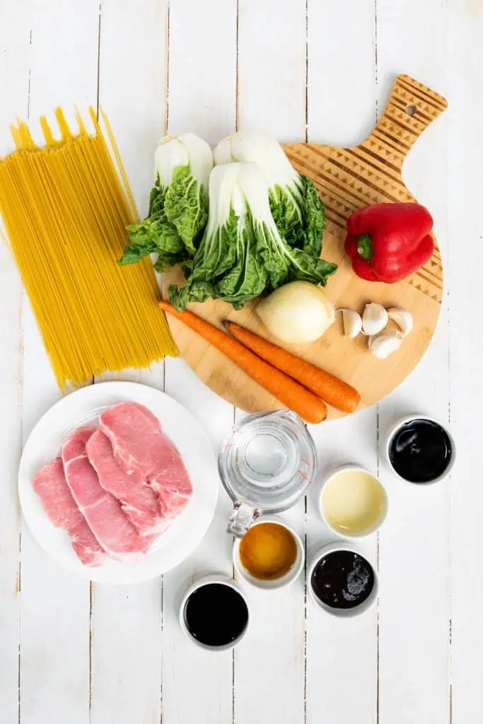 Ingredients to make Instant Pot pork Lo Mein on a white-washed countertop.
