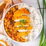 Overhead view of tender crisp pan fried pork katsu over white rice and curry