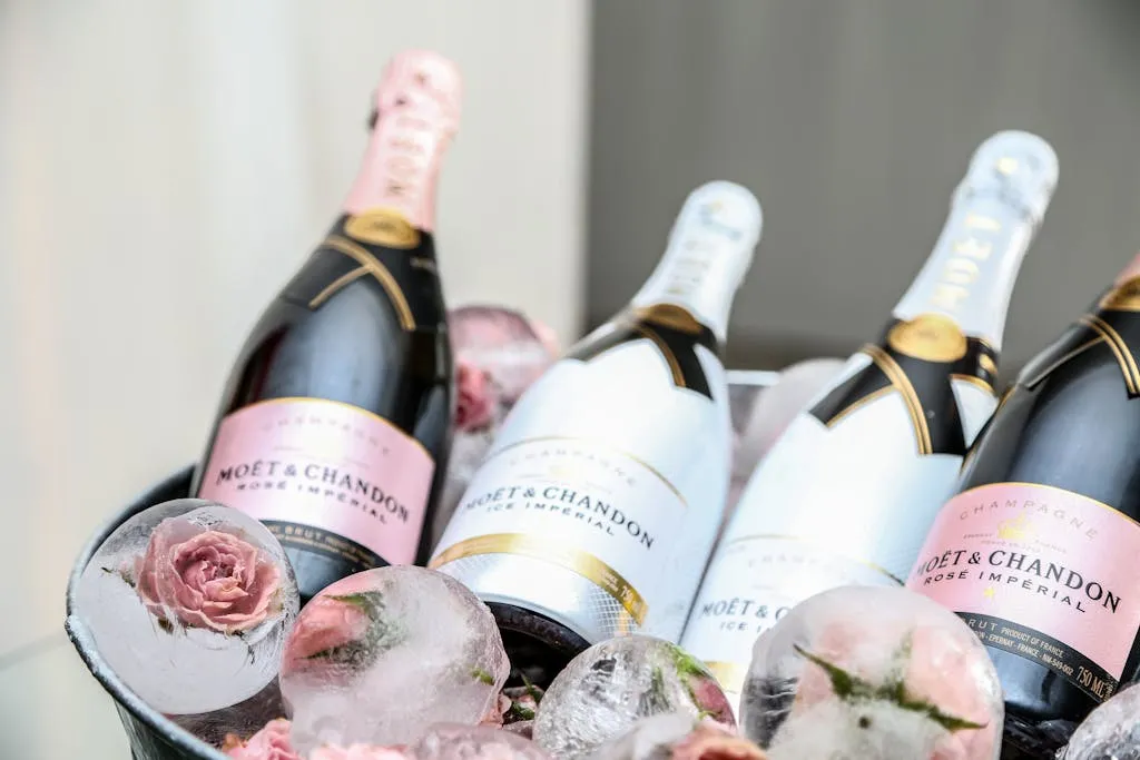 Elegant display of Moet & Chandon champagne in an ice bucket adorned with roses, perfect for celebrations.