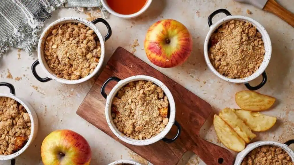 cute ceramic ramekins filled apple filling and topped with a streusel crisp