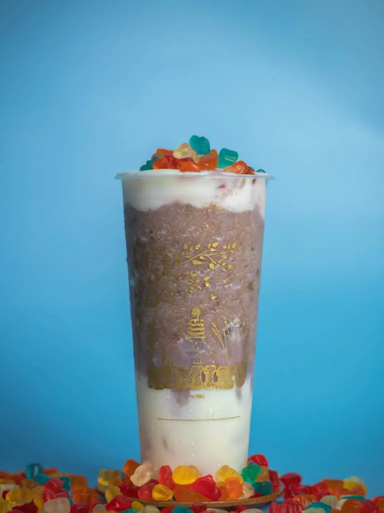 Delicious and vibrant milkshake topped with gummy candies, perfect for a sweet treat.