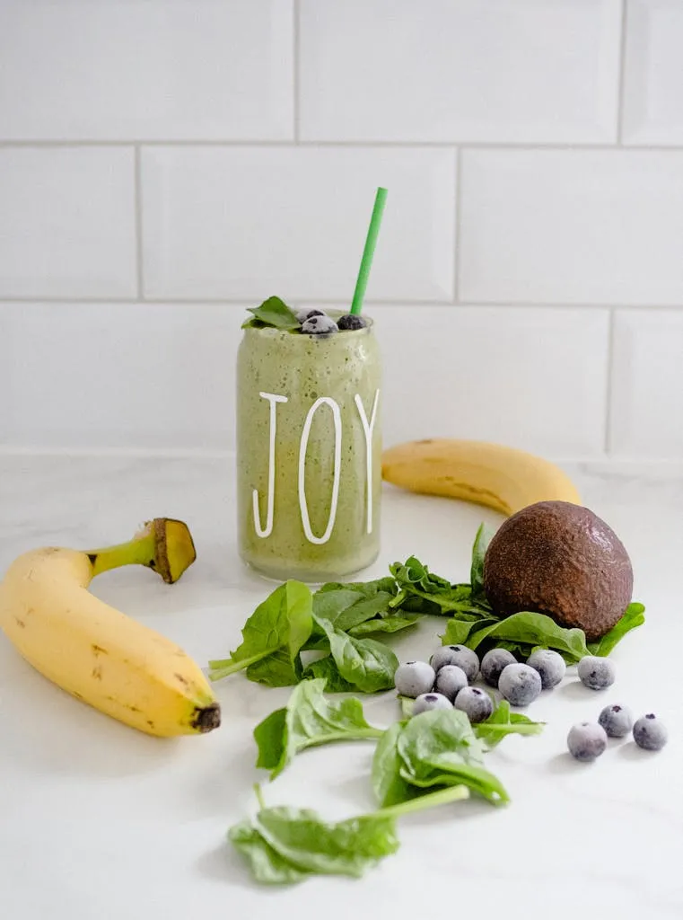 Delicious green smoothie with bananas, blueberries, and spinach for a healthy boost.