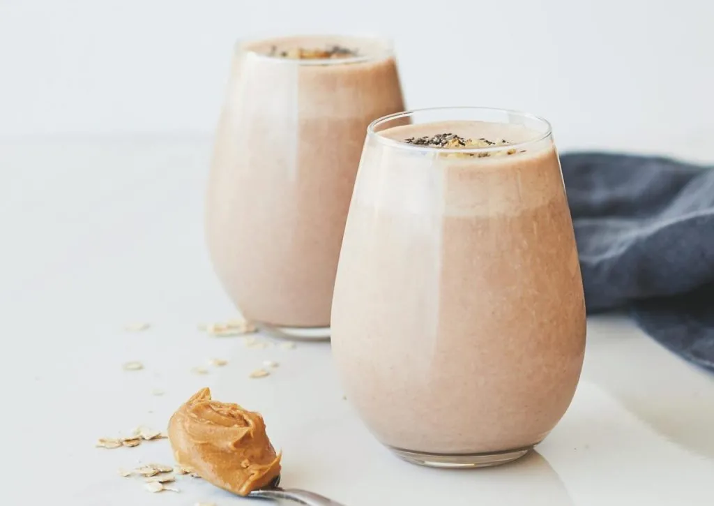Delicious peanut butter chocolate smoothies with oats in glass tumblers.