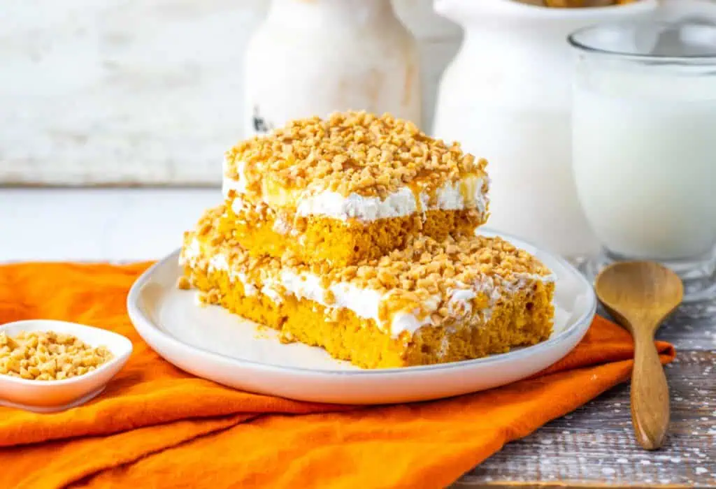 stack of caramel-drizzled whipped topping with toffee on pumpkin cake slices